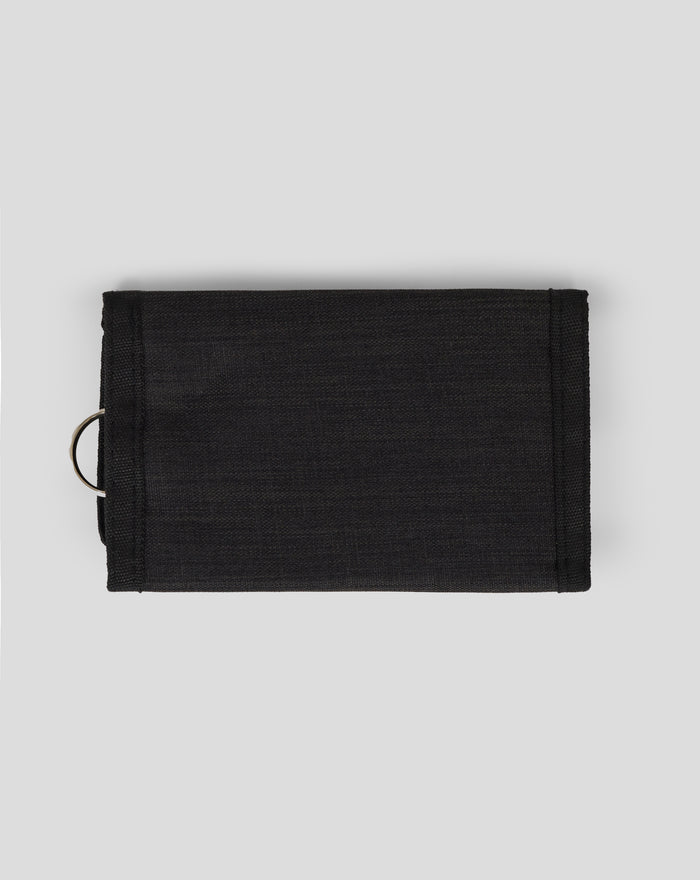 Close up of black canvas In House Ripper wallet showing Bath Rugby crest and zipper pocket