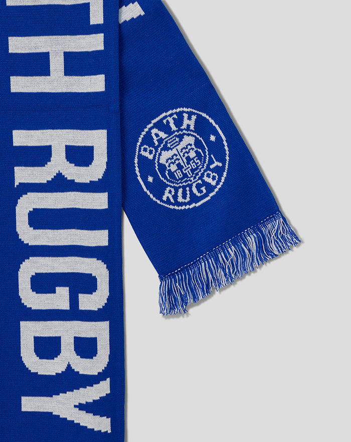 Close-up of blue Bath Rugby scarf showing fringe and the circular Bath Rugby crest.