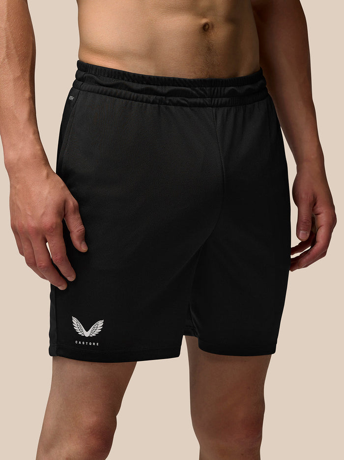 Male model in black Adapt Training 7 inch shorts with elastic waistband and side pockets, Castore branding on right thigh