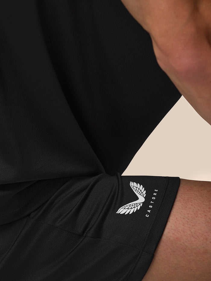 Close-up of black shorts showing Castore branding with a white wing logo near the hip.