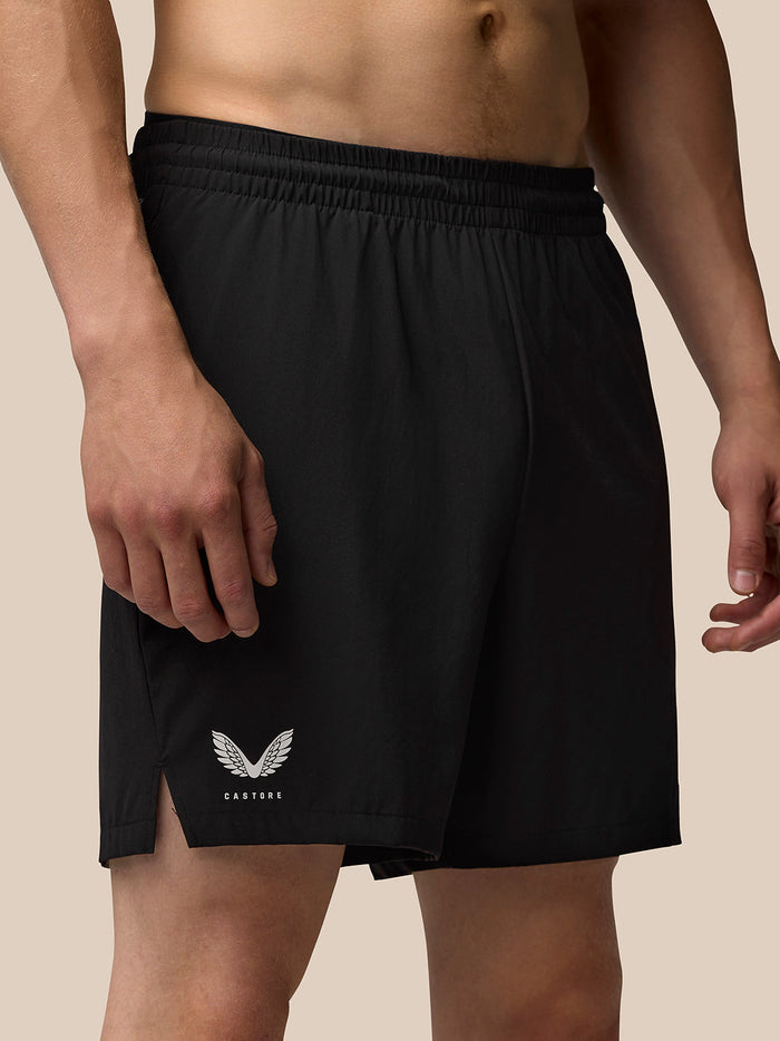 Close up of black Adapt 6 inch shorts featuring elastic waistband side pocket and Castore and Aertek branding on the thigh and rear