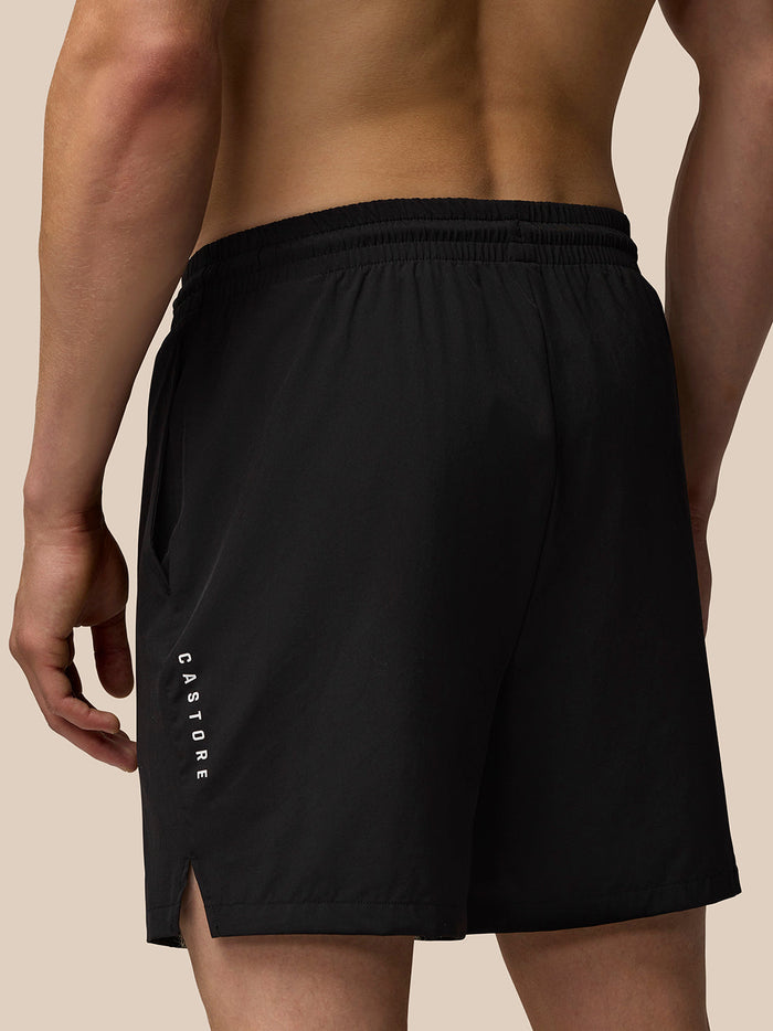 Back view of black Adapt 6 inch shorts with Castore vertical logo along left leg and Aertek branding at right rear