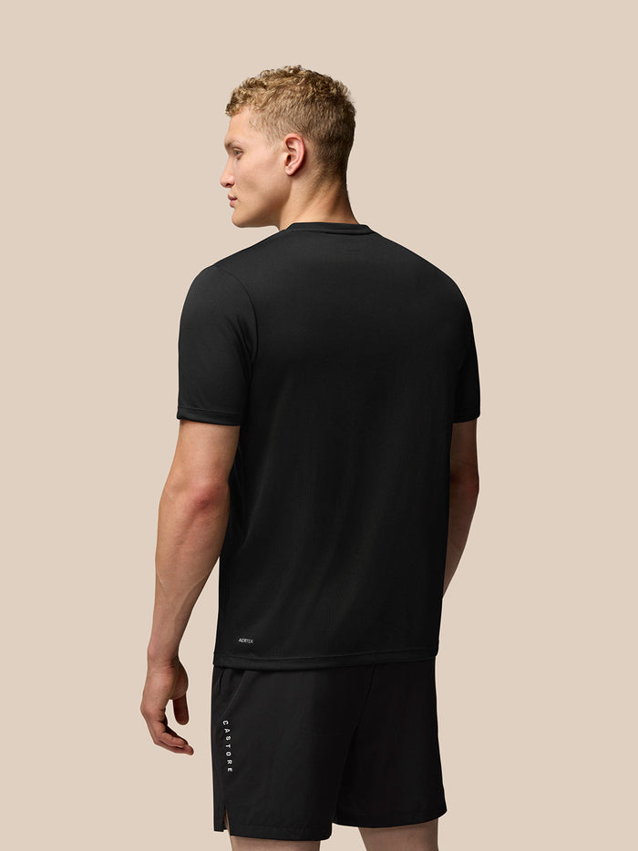 Back view of model wearing black Adapt Training T-Shirt with Aertek branding at the back hem