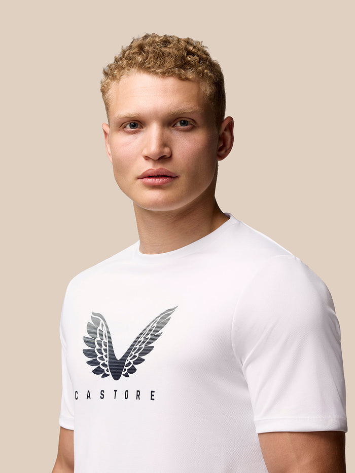 Model wearing a white Adapt Training T-Shirt with Castore wings graphic on the chest.