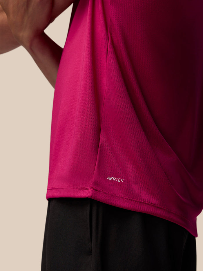 Back view of pink Adapt Training T Shirt showing AerTek branding at the hem