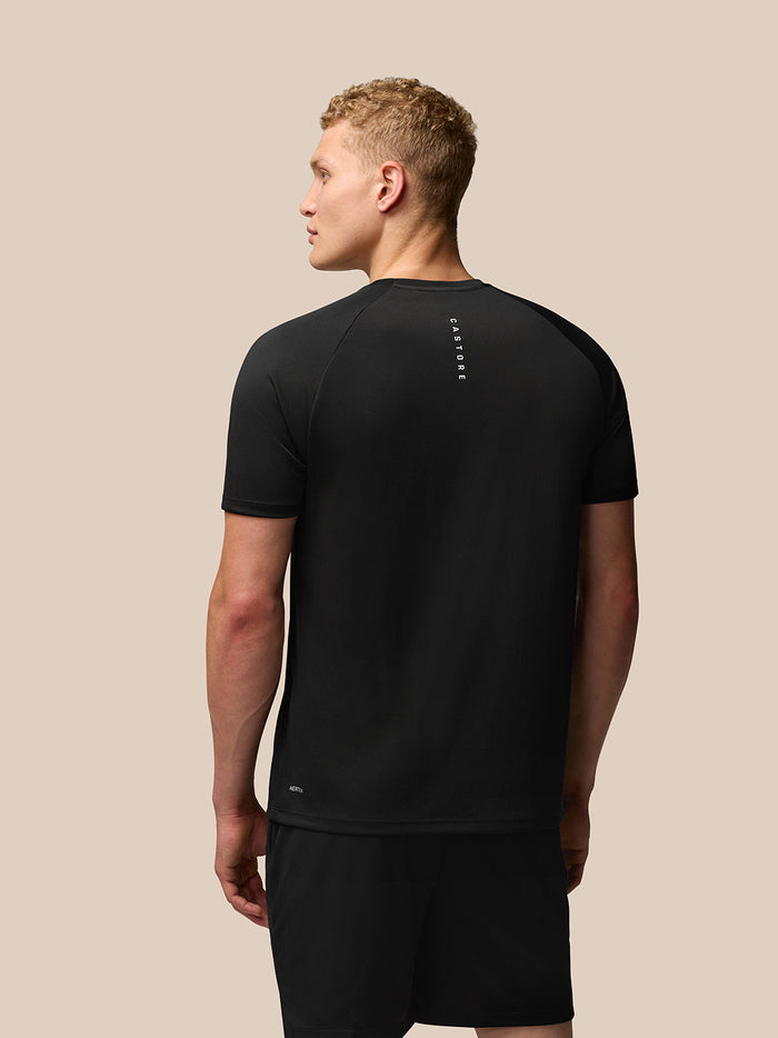 Back view of black Adapt Training T-Shirt showing vertical Castore branding on the upper back and Aertek branding at the lower back