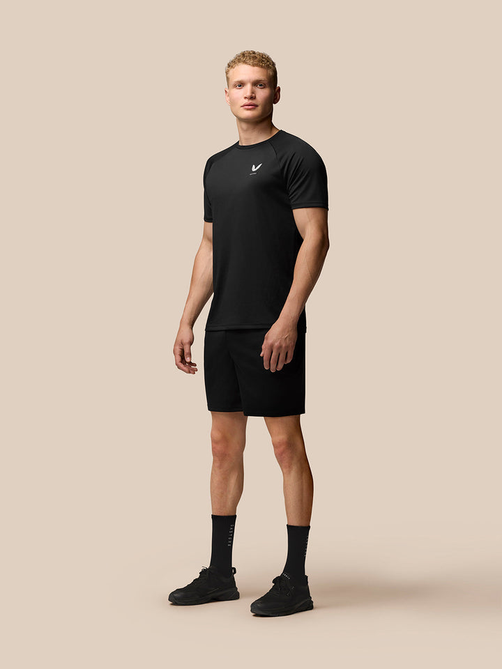 Male model wearing black Adapt Training T Shirt with raglan sleeves and Castore branding on left chest and upper back