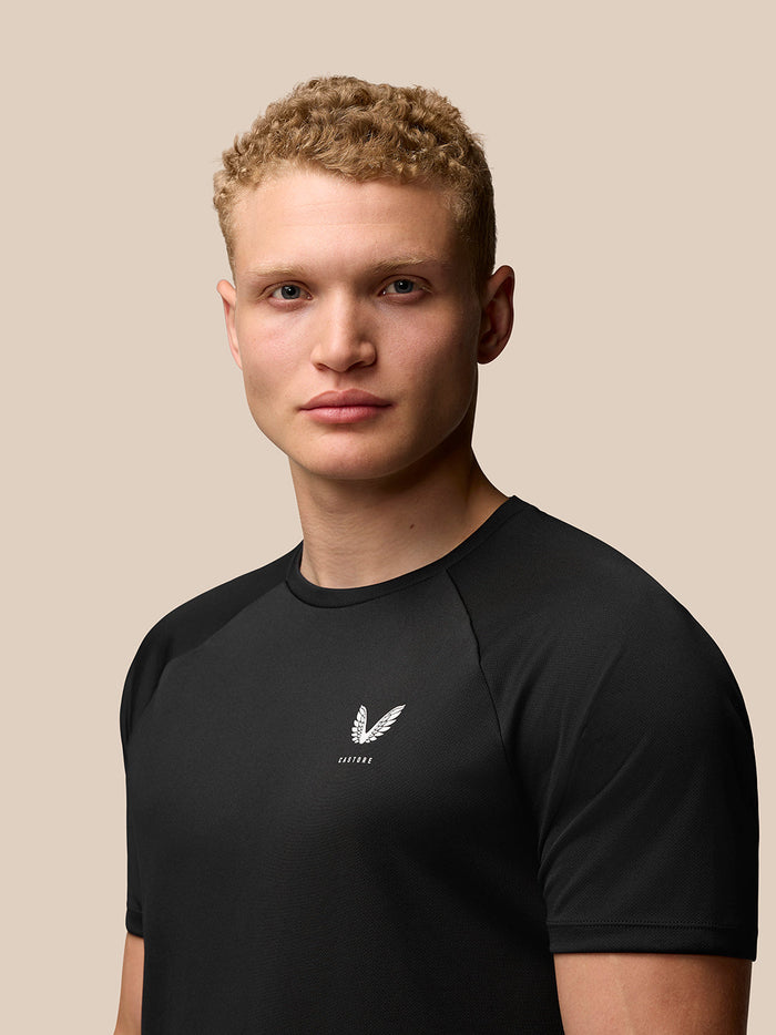 Front portrait of a model wearing black Adapt Training T-Shirt with Castore logo on the left chest