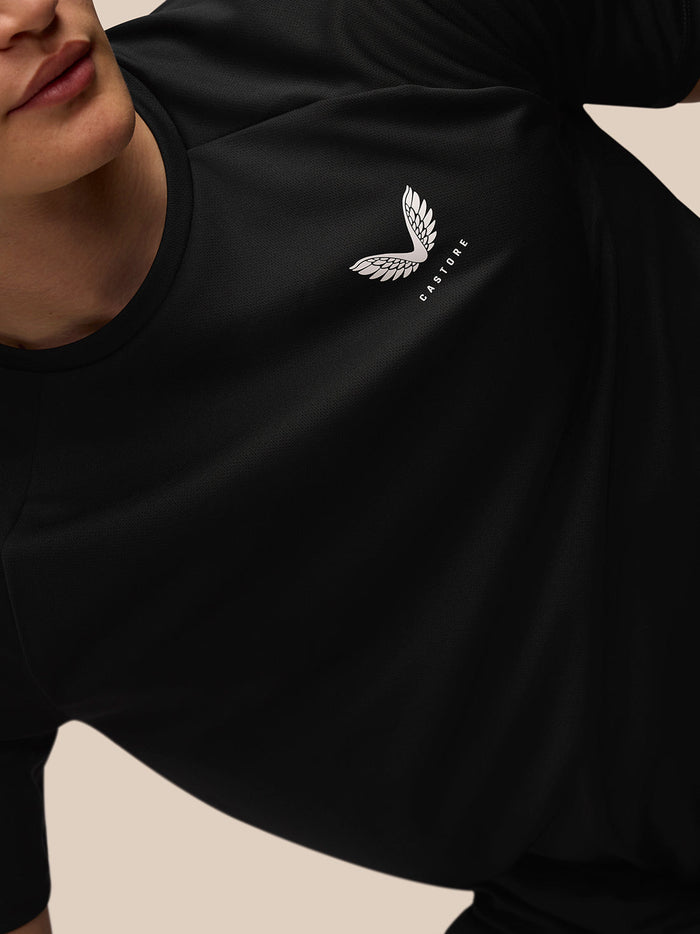 Close-up of black Adapt Training T-Shirt front with Castore logo on the left chest and branding on the upper back