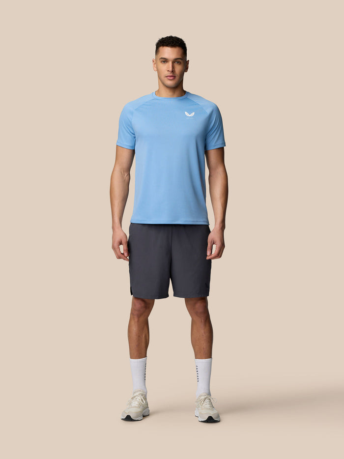 Male model wearing sky blue Adapt Training T-Shirt with Castore logo on chest and upper back.