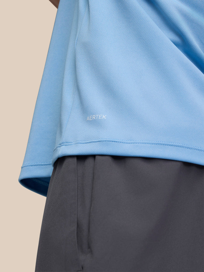 Close up of lower side of sky blue Adapt Training T-Shirt showing AERTEK text on the fabric