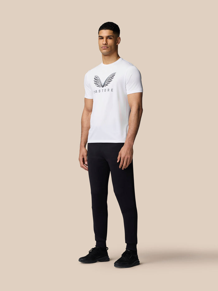 Front view of a man in a white graphic training T-shirt with Castore wings on the chest