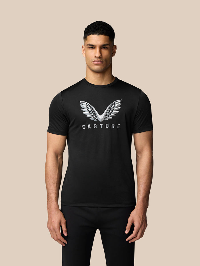 Male model wearing black short sleeve graphic T-shirt with white wings graphic on chest.