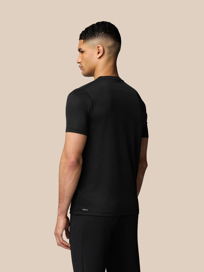 Back view of male model in black short sleeve T-shirt with small Aertek branding at lower back.