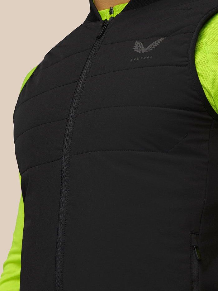 Close-up of black Apex Training Gilet with Castore logo on the chest and Protek branding on the lower back panel
