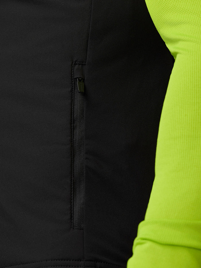 Close up of a side zip pocket on the black Apex Training Gilet with neon lime sleeve visible.