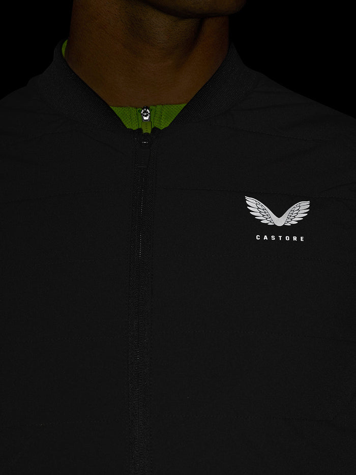 Close up of black Apex Training Gilet showing neon green neck lining and Castore logo on chest.