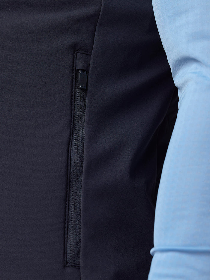 Close-up of navy Apex Training Gilet side zip pocket and fabric texture.