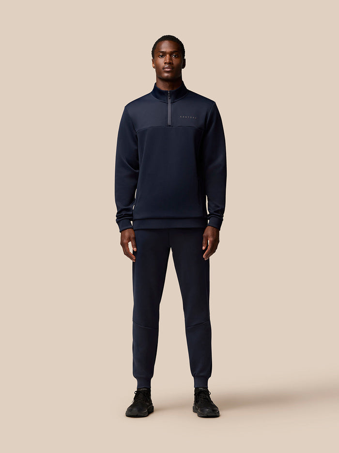 Full-body view of a model wearing navy Flex Lifestyle Joggers with a matching top.