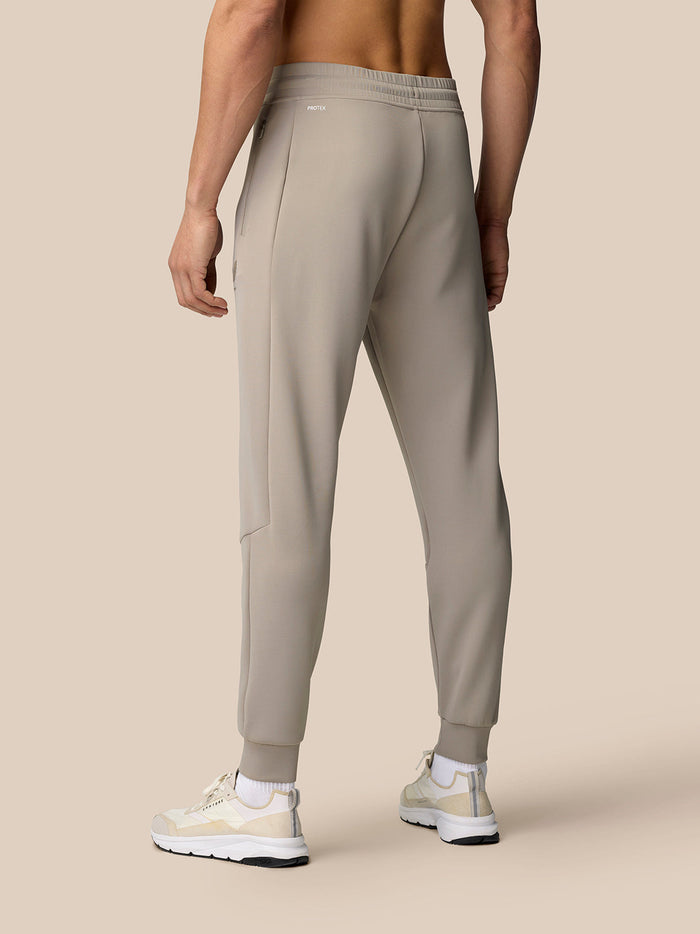 Back view of Rock Grey Flex Lifestyle Joggers showing a zip hip pocket and Castore branding on the left thigh.
