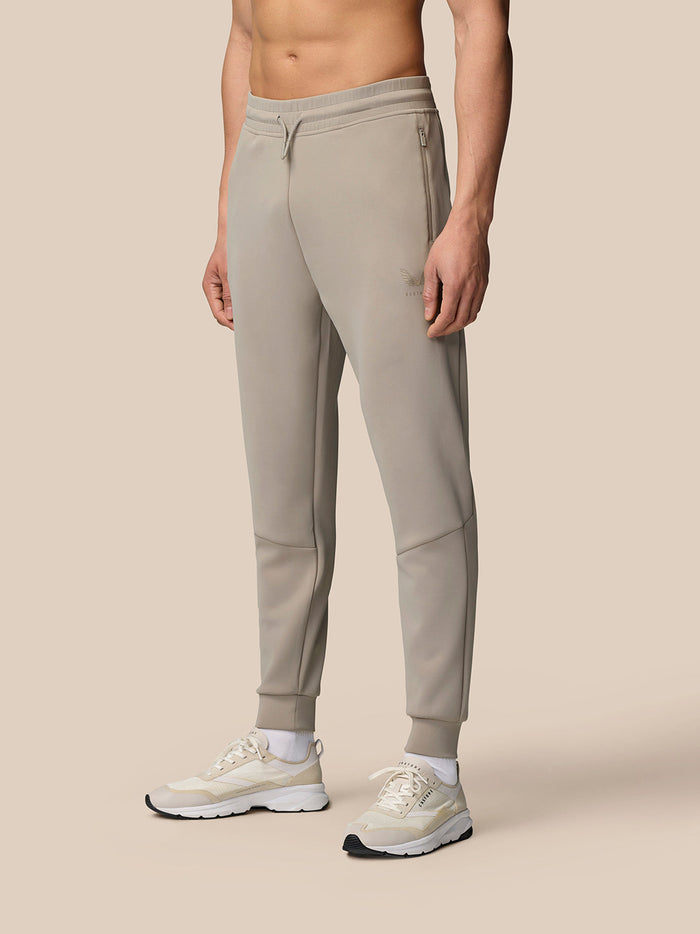 Full-length front view of a model wearing Rock Grey Flex Lifestyle Joggers with a drawstring waist and cuffed ankles.