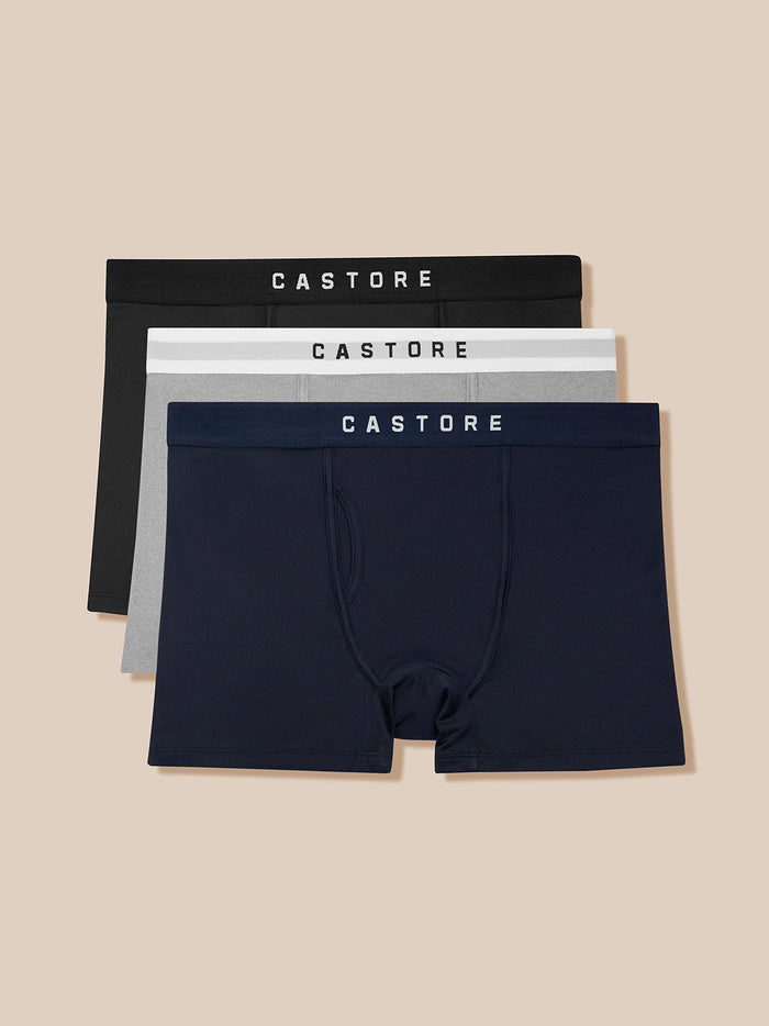 Three-pack of Castore Active boxer shorts in black grey and navy with branded waistbands.