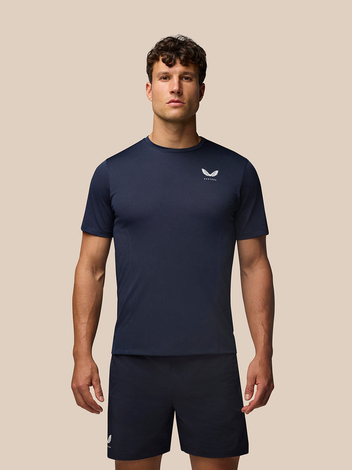 Male model wearing navy Apex Training T Shirt with engineered knit fabric and Castore logo on left chest.