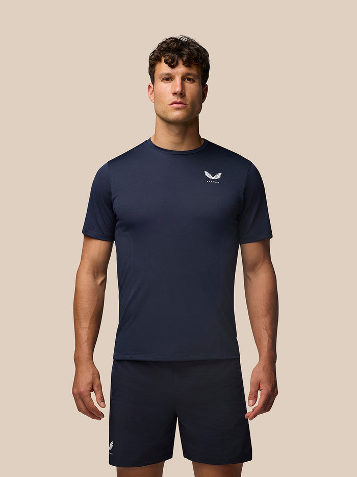 Male model wearing navy Apex Training T Shirt with engineered knit fabric and Castore logo on left chest.