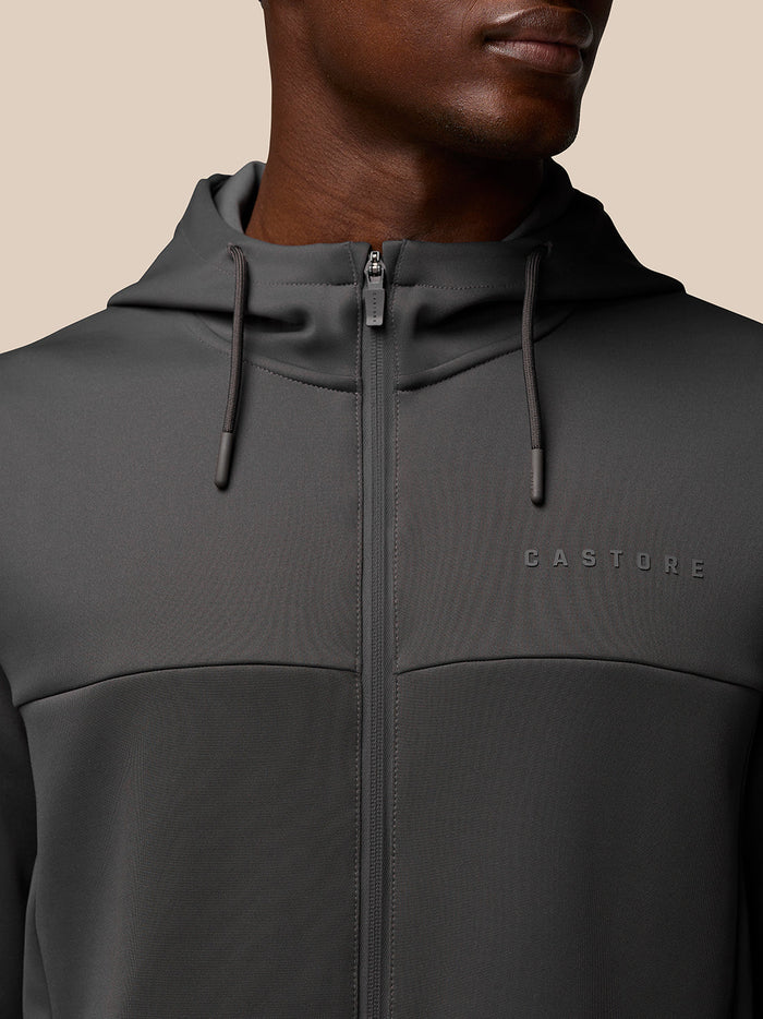 Close up of charcoal Flex Lifestyle Full Zip hoodie showing hood with drawstrings and embossed CASTORE logo on the chest