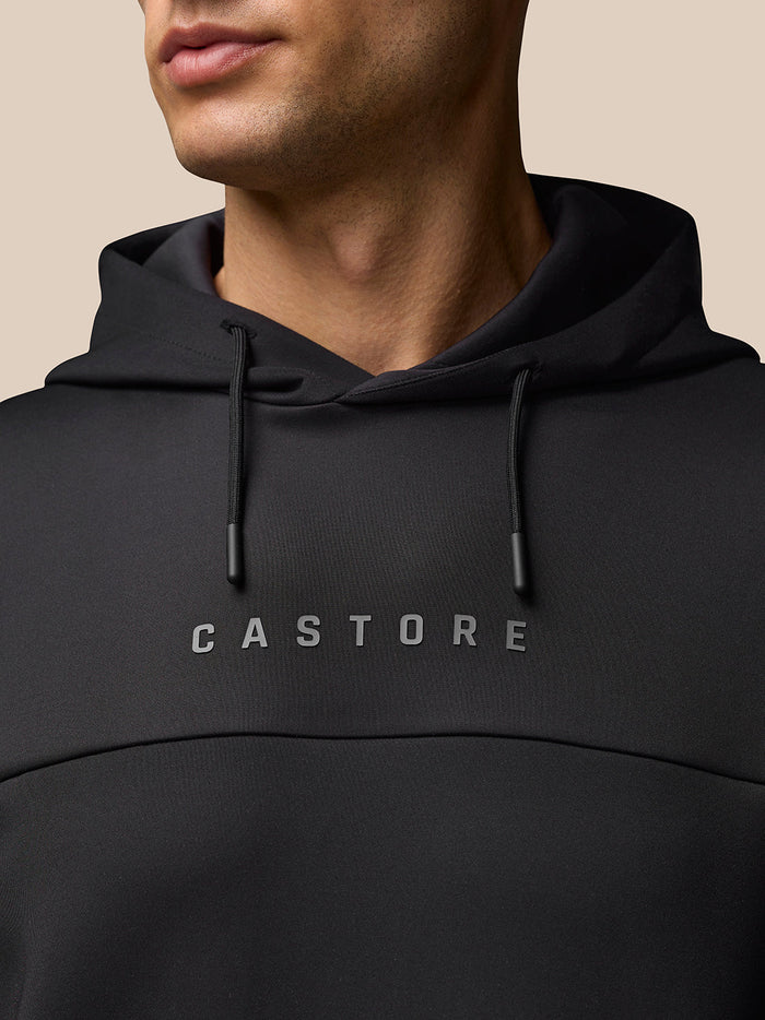 Close-up of black Flex Hoodie neckline with hood drawstrings and CASTORE logo on the chest