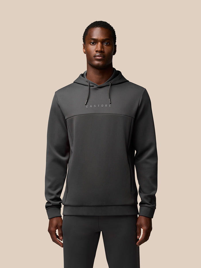 Man wearing charcoal flex lifestyle hoodie with Castore branding on chest
