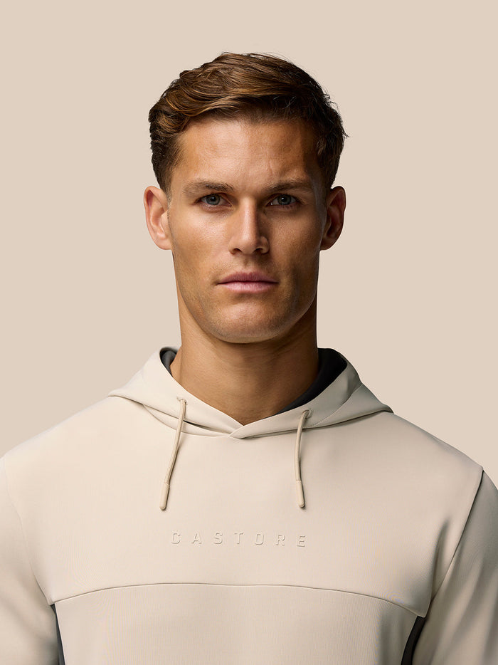 Back view of beige Flex Lifestyle Hoodie with hood down on a model