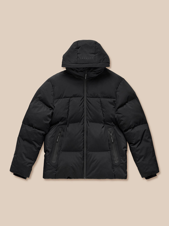 Front view of black hooded puffer jacket with zip pockets showcased as a product shot