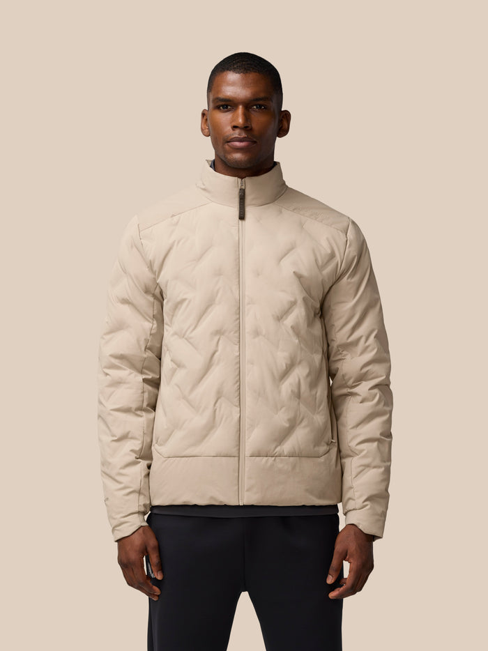 Mushroom padded jacket on man with quilted front and zip pockets