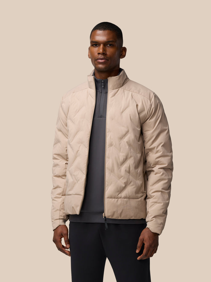 Beige padded jacket with high collar and zip front shown on model