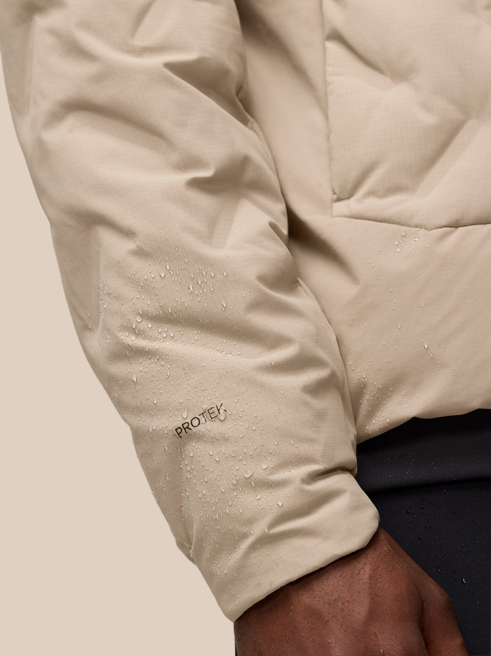 Beige padded jacket sleeve with water droplets and ProTek label