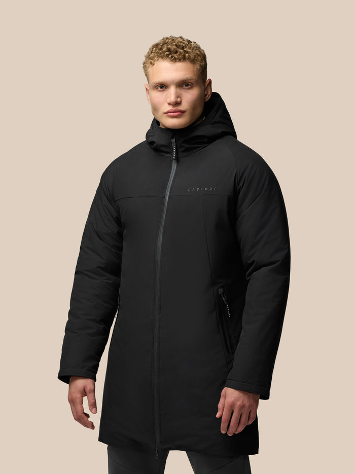 Person wearing black Longline Wadded Jacket with hood, ProTek water resistance and front zip pockets