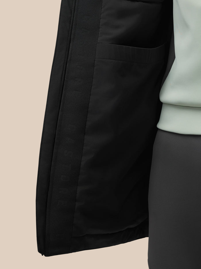 Close up of the black longline jacket interior showing an internal pocket