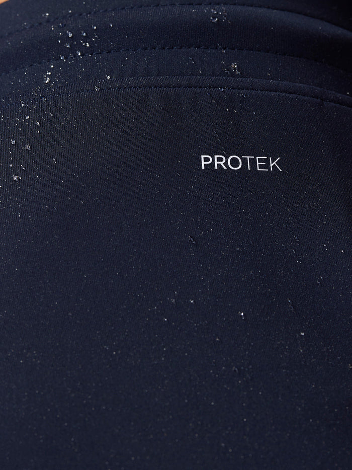 Close-up of navy fabric with water droplets and ProTek branding on the Flex Shorts.