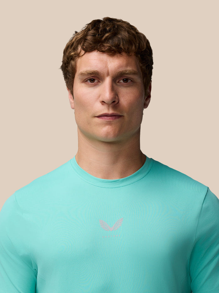 Close-up of a male model wearing Light Aqua Zone Training T-Shirt showing the crew neck and chest logo
