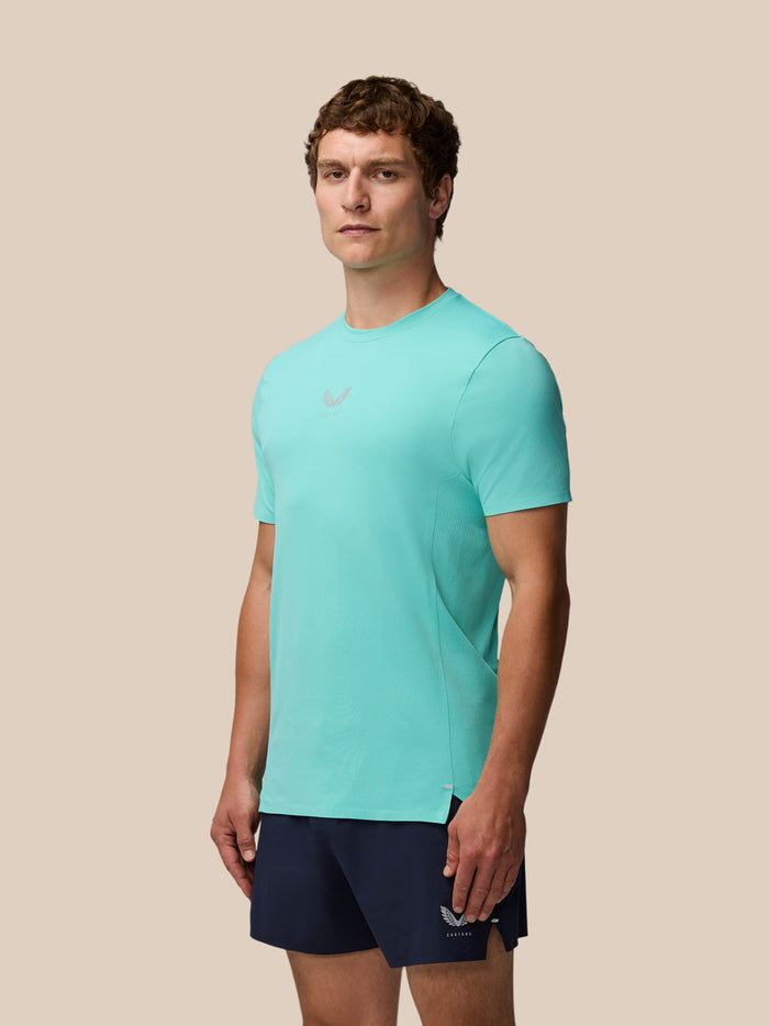 Male model in Light Aqua Zone Training T-Shirt with navy shorts in a studio shot