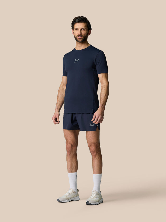 Male model in navy Zone Training T-Shirt with matching shorts, full-body front view and small chest logo.