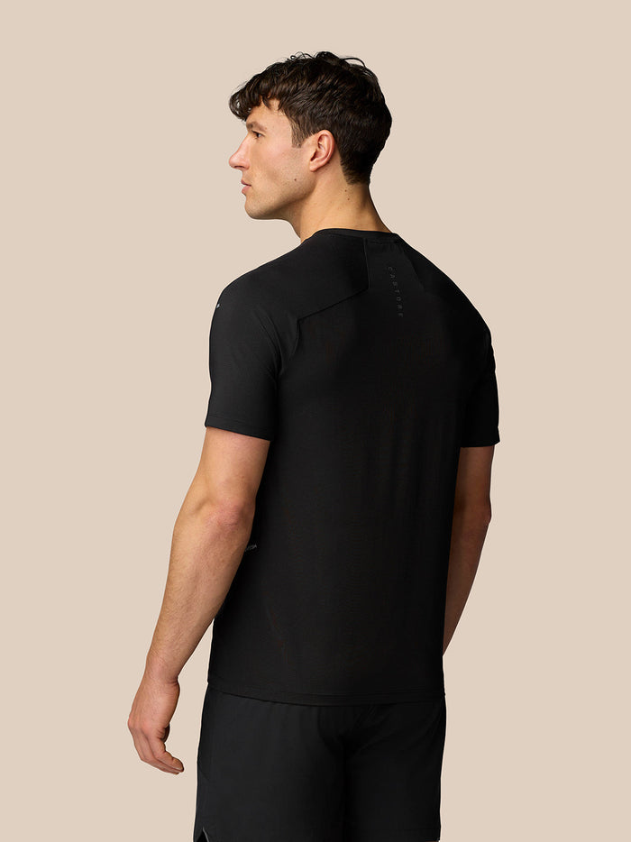 Back view of a man in a black Apex training T shirt showing a streamlined fit and subtle Castore branding on the back