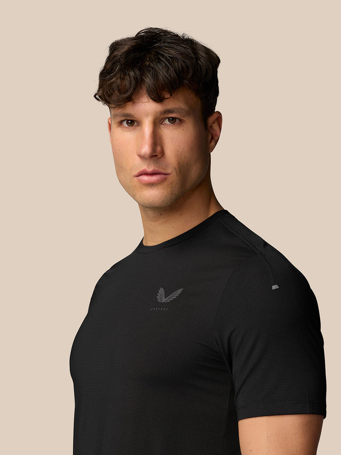 Male model wearing black Apex Training T-Shirt with a subtle Castore logo on the chest