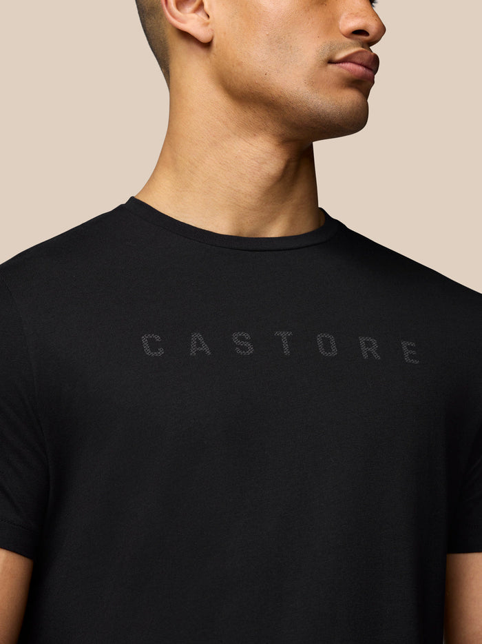 Close up of black Castore graphic T shirt showing subtle chest lettering.