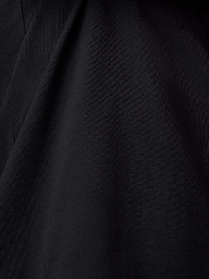 Close up of black fabric texture and folds from the T shirt.