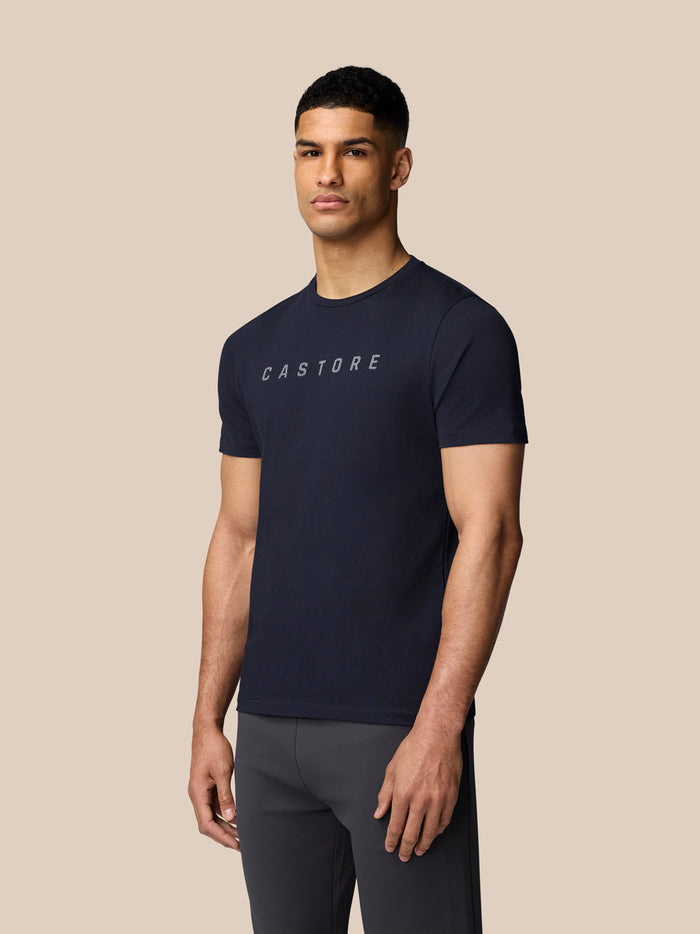 Male model wearing navy Castore graphic T shirt with crew neck and chest logo