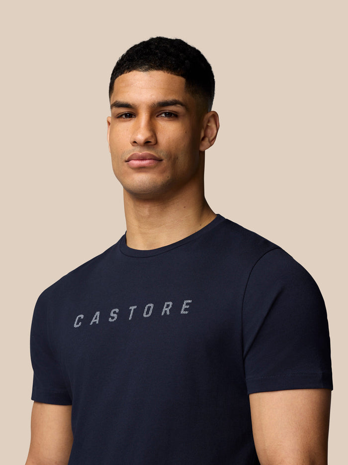 Close up of a navy Castore Graphic Lifestyle T-Shirt showing the CASTORE lettering on the chest.