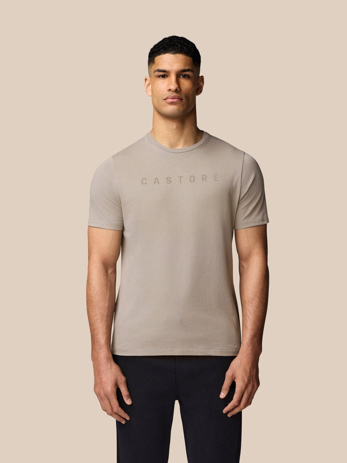 Male model wearing a Rock Grey Castore graphic T-shirt with crew neck and drop shoulders