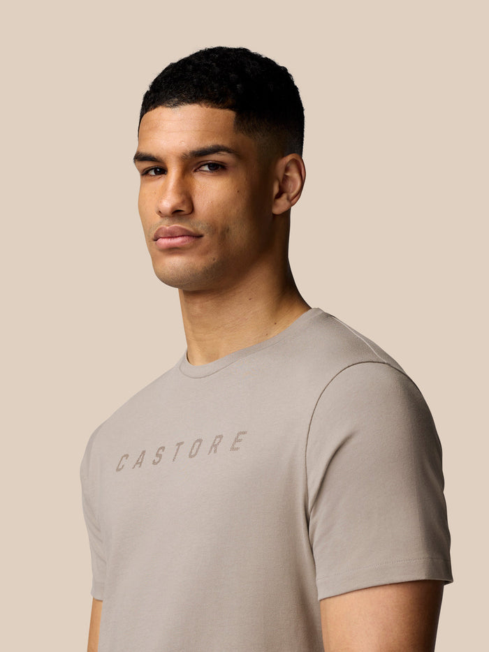 Close up of male model wearing a Rock Grey Castore graphic T-shirt with crew neck